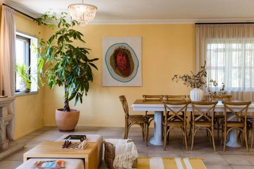 a living room with a table and chairs at Azurara Guesthouse in Azurara