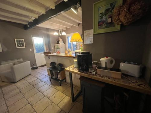 a kitchen with a counter and a counter top at Chambres et Gîte PEYROUTAS " CAMILLE" Vignonet St Emilion in Vignonet