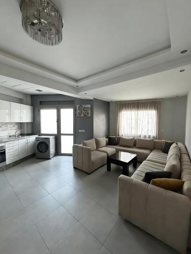 a large living room with couches and a table at Appart Hotel Bloom in Al Hoceïma