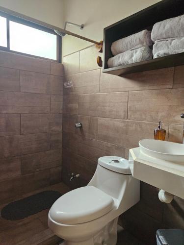 a bathroom with a toilet and a sink at MarLis in Quebrada Seca