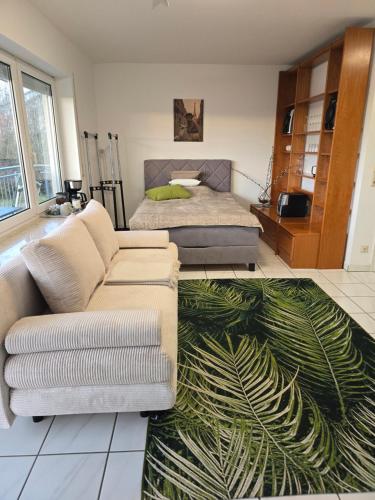 a living room with a couch and a bed at Apartment Kliniknähe in Idar-Oberstein