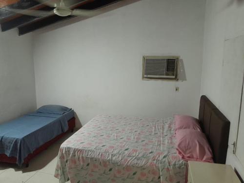 a bedroom with two beds and a ceiling fan at La Petite Maison Mariano Casa in Limpio