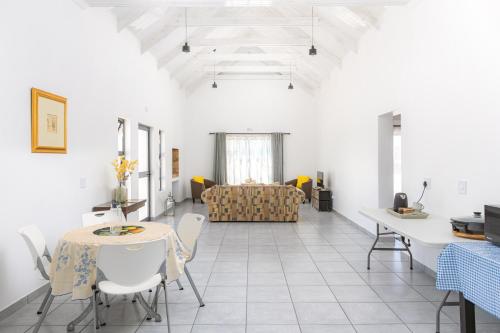 a living room with a table and a couch at The North Atlantic Sands Beach House in Velddrif