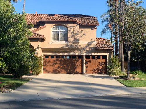 a house with a gate and a driveway at Private bedroom and bathroom in Rancho Santa Margarita