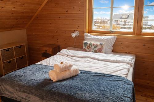 a bedroom with two beds in a wooden cabin at Myranhuset - Amazing View in Moskenes