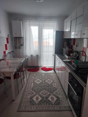 a kitchen with a table and a dining room at Apartament Abby in Sighişoara
