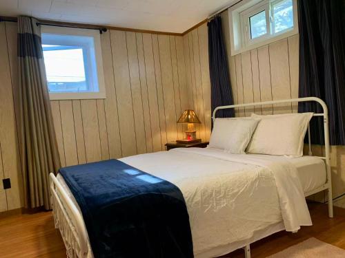 a bedroom with a white bed and a window at 101 Harborview Drive in North Rustico
