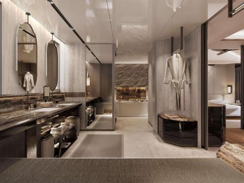 a bathroom with two sinks and a bath tub at Navera Phuket - MGallery Collection in Surin Beach