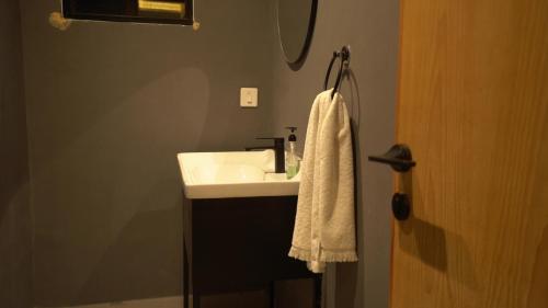 a bathroom with a sink and a white towel at Oasis Living in Islamabad
