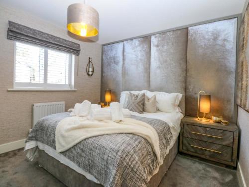 a bedroom with a large bed and a window at 2 Glan Yr Aber in Colwyn Bay