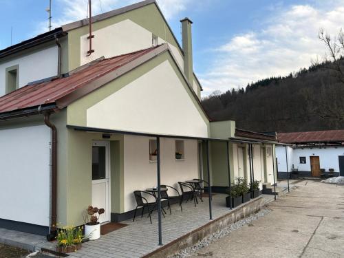 a building with chairs and tables on a patio at Jedlinka in Palota