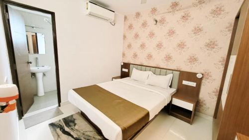 a small bedroom with a bed and a bathroom at 4 BHK villa with private Jacuzzi & Shared pool- Anjuna in Anjuna