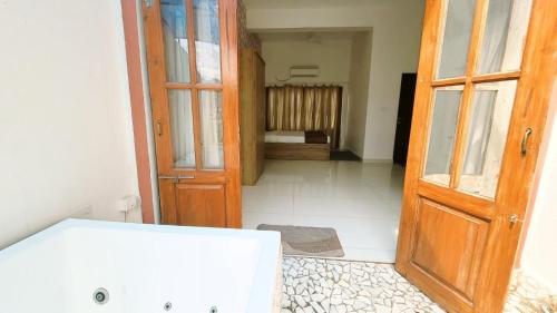 an open door to a room with a bathroom at 4 BHK villa with private Jacuzzi & Shared pool- Anjuna in Anjuna