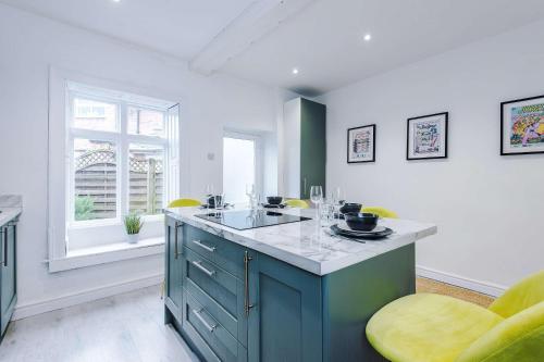 a kitchen with a blue island in a room at 15A Well Street in Ruthin