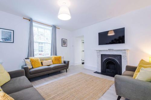a living room with two couches and a fireplace at 15A Well Street in Ruthin