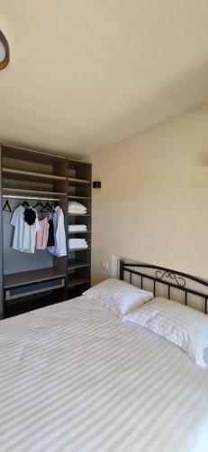 a bedroom with two beds and a closet at Sea View House with Jacuzzi - Casa Bianca Brač in Selca