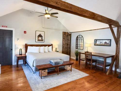 a bedroom with a bed and a table and a desk at The Black Walnut Inn in Amherst