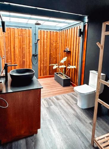 a bathroom with a sink and a toilet at OBOĒ Gardenstē in Pereybere
