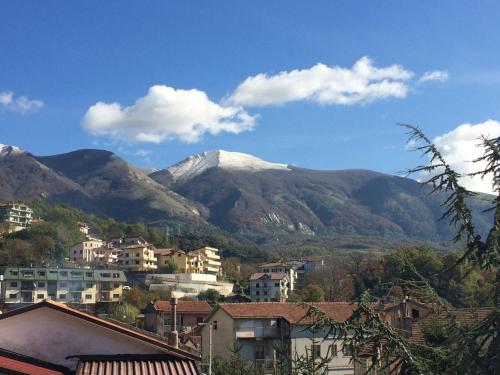 a city with a mountain in the background with houses at Hotel San Nicola in Lagonegro