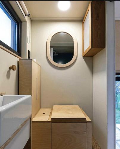 a small bathroom with a sink and a mirror at La Tiny De Fy in Aywaille