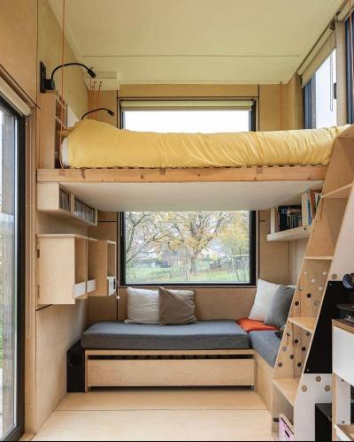 a tiny house with a bunk bed and a window at La Tiny De Fy in Aywaille