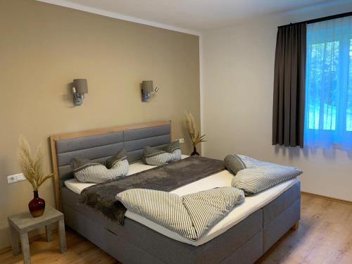 a bedroom with a large bed with pillows on it at Ferienhaus Krenn in Bad Gleichenberg