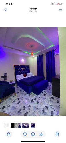 a bedroom with two beds and blue curtains at Bluespring luxury hotel in Elu