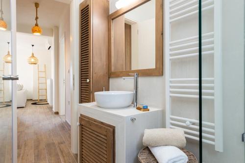 a bathroom with a white sink and a mirror at Sarris Village Luxury 2 in Sarakíniko