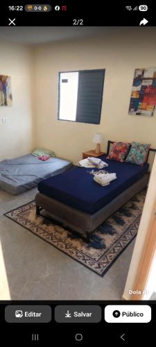 a bedroom with two beds in a room at Edicula para temporada in Piracicaba