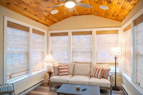 a living room with windows and a couch at Canalside Cottage 3BR Lake Access Dock Fire Pit in Waterloo
