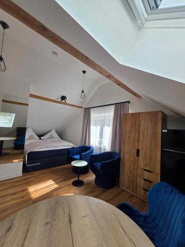 a bedroom with a bed and a table and chairs at Modern apartment in downtown in Schwäbisch Hall