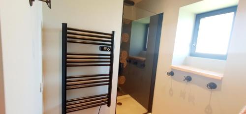 a bathroom with a closet with a window at la petite roche in Lanildut