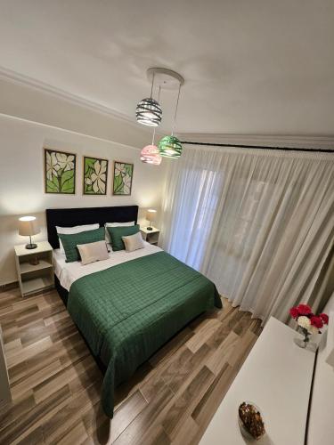 a bedroom with a bed with a green blanket at Elite 3 BR Apartment in Zayed in Sheikh Zayed