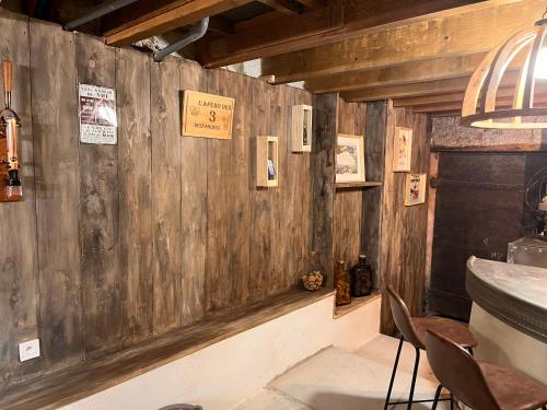 a restaurant with a wooden wall with signs on it at Villa vacances les 3 Restanques in Ollioules
