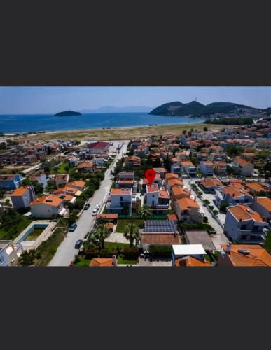 an aerial view of a city with houses and the ocean at Diamond Deluxe Loft in Iraklitsa