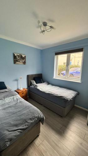 a bedroom with two beds and a window at Luxury Suntrap in Private Complex St Leonards in Hastings