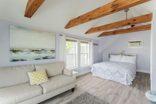 a living room with a couch and a bed at Oceanfront Cottage - Steps from Short Sands Beach! in York