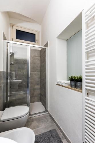 a bathroom with a shower and a toilet and a sink at Ca' Lumaga -Charming Holiday Studio in Chiavenna