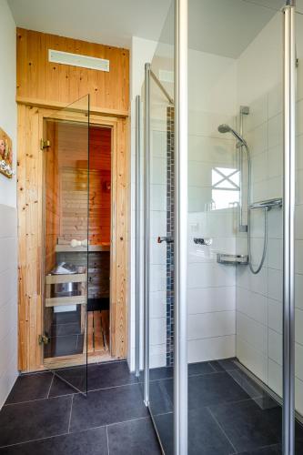 a bathroom with a shower and a glass shower stall at Min Leefste in Prerow