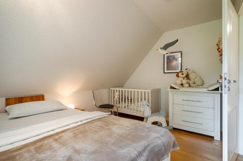 a bedroom with a bed and a crib at Emma in Prerow