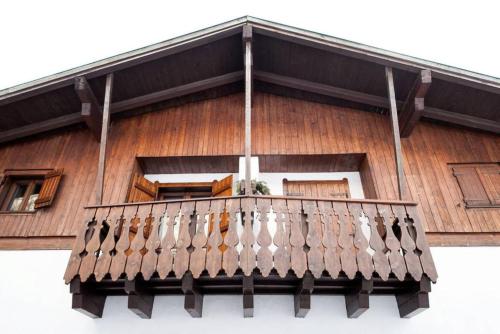 a balcony of a wooden house with windows at Casa Remo 1 in San Vito di Cadore