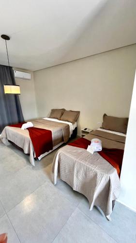 a room with two beds in a room at Pousada Iraquara in João Pessoa