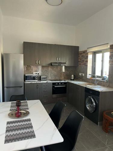 a kitchen with a table and chairs in a kitchen at Central Stone Living in Peyia