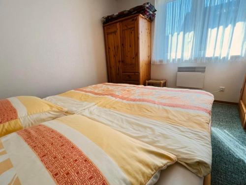 a bedroom with two beds and a window at Ferienwohnung Westi in Thiessow