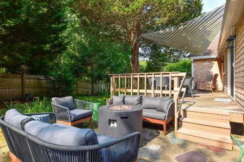a patio with two chairs and a fire pit at Less than 5 Miles to Rock Harbor in Orleans