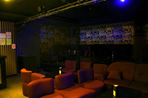 a room with a bar with orange and purple chairs at Phoenicia Grand Hotel in Bucharest