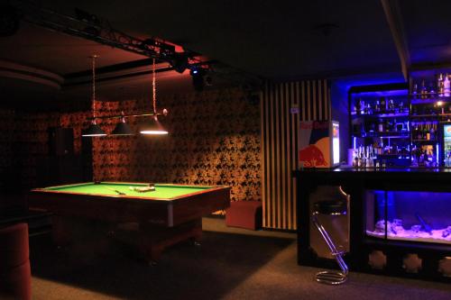a room with a pool table and a bar at Phoenicia Grand Hotel in Bucharest