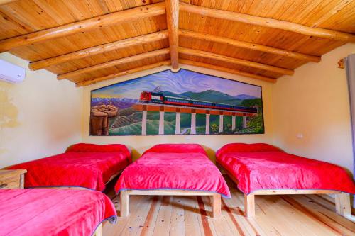 a room with three red cushioned beds in it at Cabañas las Gemelas in Areponapuchi