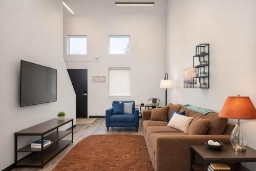 a living room with a couch and a tv at Downtown Appleton Condo 2 Bedroom Loft Sleeps 6 in Appleton