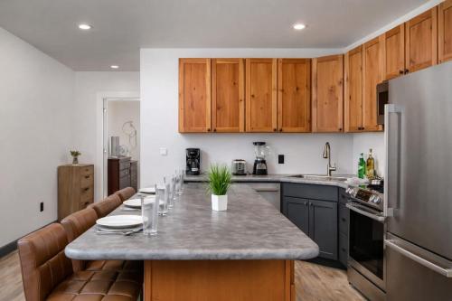 a kitchen with wooden cabinets and a large counter top at Downtown Appleton Condo 2 Bedroom Loft Sleeps 6 in Appleton